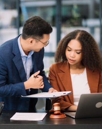 Business and lawyers discussing contract papers. with brass scal Business and lawyers discussing contract papers with brass scale on desk in office. Law, legal services, advice, justice and law concept .
