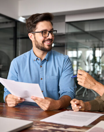 Female advisor attorney lawyer or bank manager consulting client investor reading document at business meeting reviewing legal paper working in office. Financial planning, consultancy advisory service
