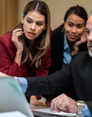 Group of multi-Ethnic businessman and businesswoman working in office. Attractive employee brainstorm and meeting as team, plan and discuss project in workplace. Corporate of modern colleagues concept